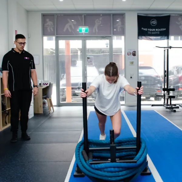woman-pulls-sled-indoors woman-pulls-sled-indoors